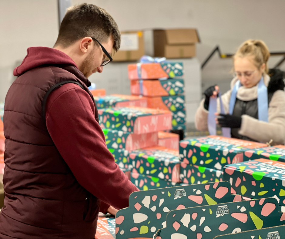 Warehouse Team Preparing Christmas Hamper Gifts for Dispatch